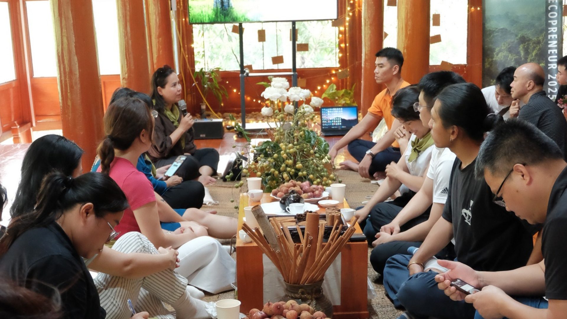 A group of young innovators gathered for a community incubation workshop in a sunlit space.